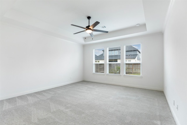 11914 Parsifal Creek Rd, Humble, TX 77346 - spare room featuring a tray ceiling, carpet, a ceiling fan, baseboards, and ornamental molding