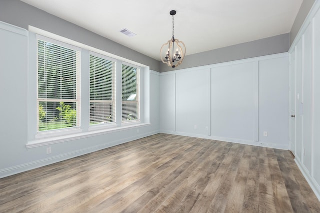 19276 Yellow Chestnut Ln, New Caney, TX 77357 - unfurnished dining area with a chandelier, healthy amount of natural light, wood finished floors, and baseboards