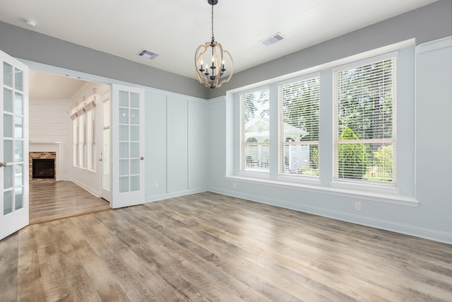 19276 Yellow Chestnut Ln, New Caney, TX 77357 - unfurnished dining area featuring french doors, a chandelier, wood finished floors, and baseboards