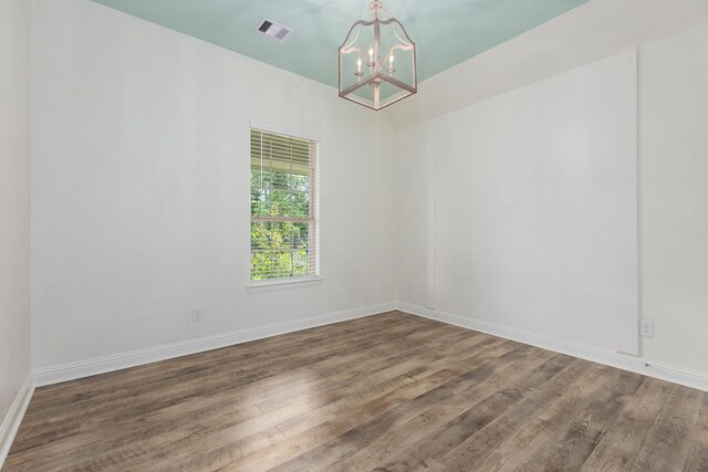 19276 Yellow Chestnut Ln, New Caney, TX 77357 - empty room featuring a chandelier, wood finished floors, and baseboards