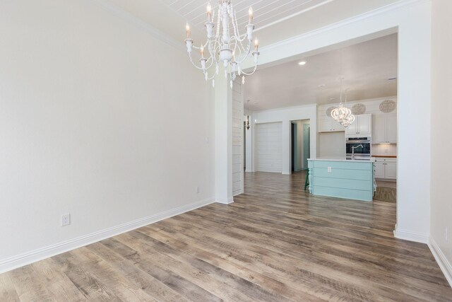 19276 Yellow Chestnut Ln, New Caney, TX 77357 - unfurnished living room featuring a chandelier, wood finished floors, baseboards, ornamental molding, and recessed lighting