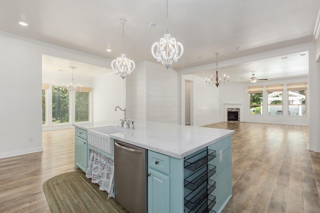 19276 Yellow Chestnut Ln, New Caney, TX 77357 - kitchen with stainless steel dishwasher, a chandelier, a sink, blue cabinets, and open floor plan