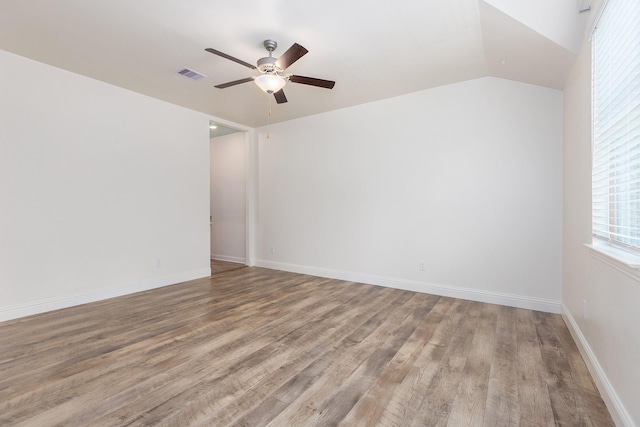 19276 Yellow Chestnut Ln, New Caney, TX 77357 - empty room featuring a ceiling fan, wood finished floors, baseboards, and vaulted ceiling