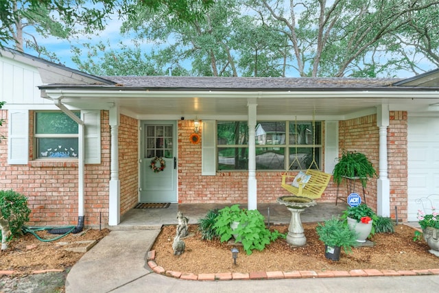 1103 Hillcrest Dr, Conroe, TX 77301 - entrance to property featuring a porch, brick siding, and roof with shingles