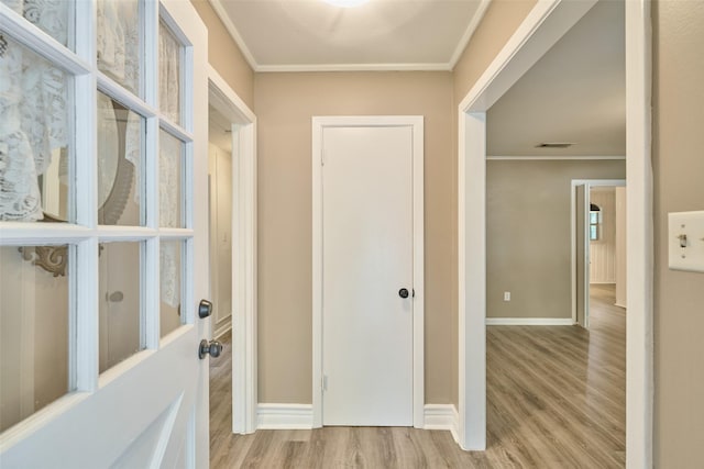 1103 Hillcrest Dr, Conroe, TX 77301 - hallway with ornamental molding, wood finished floors, and baseboards