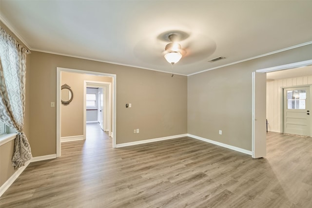 1103 Hillcrest Dr, Conroe, TX 77301 - empty room featuring crown molding, a ceiling fan, baseboards, and light wood-type flooring