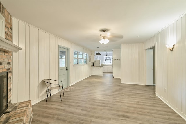 1103 Hillcrest Dr, Conroe, TX 77301 - unfurnished living room featuring wood finished floors, a fireplace, and ceiling fan