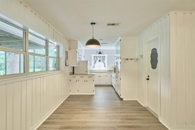 1103 Hillcrest Dr, Conroe, TX 77301 - hallway with healthy amount of natural light, light wood-style floors, and a sink