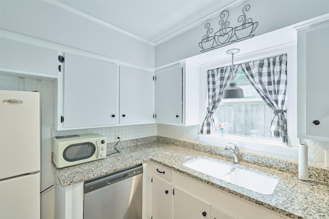 1103 Hillcrest Dr, Conroe, TX 77301 - kitchen with white appliances, a sink, light stone counters, and backsplash