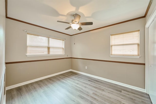 1103 Hillcrest Dr, Conroe, TX 77301 - empty room with light wood finished floors, ornamental molding, baseboards, and a ceiling fan