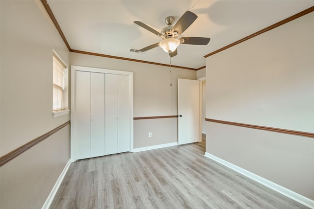 1103 Hillcrest Dr, Conroe, TX 77301 - unfurnished bedroom featuring wood finished floors, ornamental molding, baseboards, a closet, and a ceiling fan