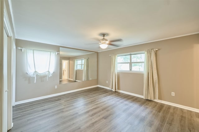1103 Hillcrest Dr, Conroe, TX 77301 - unfurnished room with a ceiling fan, baseboards, wood finished floors, and crown molding