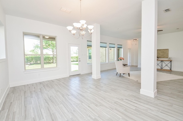 810 Sunbeam Creek Ct, Richmond, TX 77406 - unfurnished living room featuring a chandelier, healthy amount of natural light, baseboards, and light wood-style floors