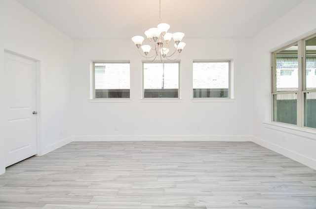 810 Sunbeam Creek Ct, Richmond, TX 77406 - spare room featuring a chandelier, healthy amount of natural light, and light wood-type flooring