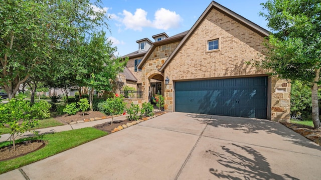 810 Sunbeam Creek Ct, Richmond, TX 77406 - view of front of home featuring stone siding, driveway, an attached garage, and brick siding