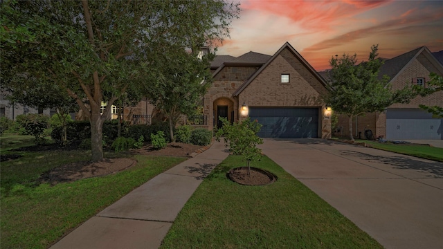 810 Sunbeam Creek Ct, Richmond, TX 77406 - view of front of property with concrete driveway, stone siding, a garage, brick siding, and a lawn