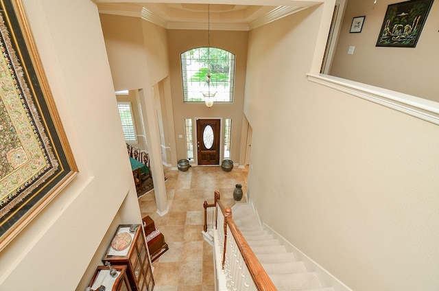 5703 Bent Arbor Ln, Katy, TX 77450 - entryway with a towering ceiling, ornamental molding, light tile patterned floors, stairs, and a chandelier