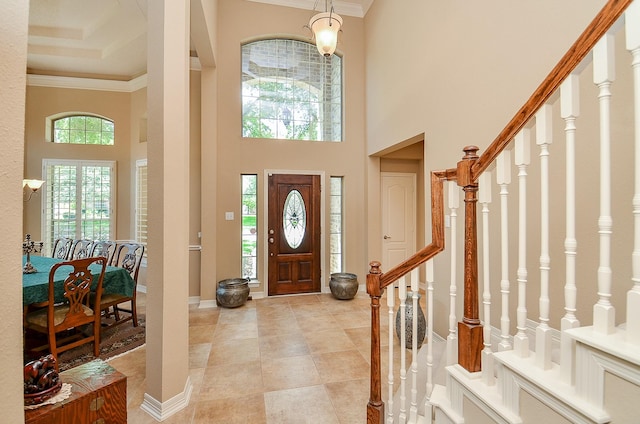 5703 Bent Arbor Ln, Katy, TX 77450 - foyer featuring stairs, crown molding, a high ceiling, light tile patterned floors, and baseboards