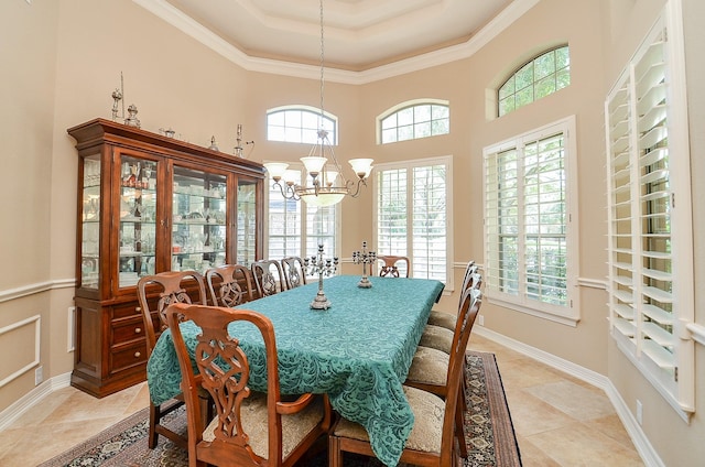 5703 Bent Arbor Ln, Katy, TX 77450 - dining space featuring healthy amount of natural light, a tray ceiling, a chandelier, crown molding, and baseboards