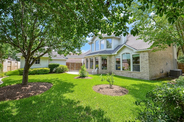 5703 Bent Arbor Ln, Katy, TX 77450 - back of house featuring brick siding, central air condition unit, and a shingled roof