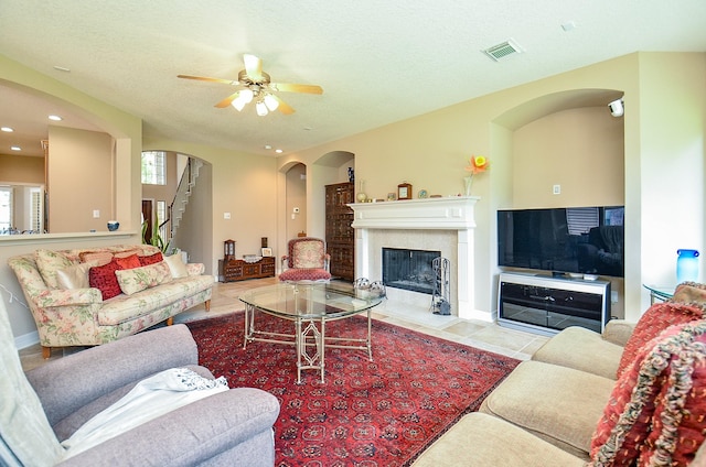 5703 Bent Arbor Ln, Katy, TX 77450 - living area with tile patterned floors, arched walkways, a ceiling fan, a tile fireplace, and recessed lighting