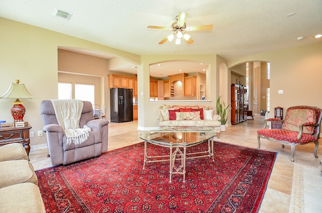 5703 Bent Arbor Ln, Katy, TX 77450 - living room with arched walkways, light tile patterned flooring, ceiling fan, and recessed lighting