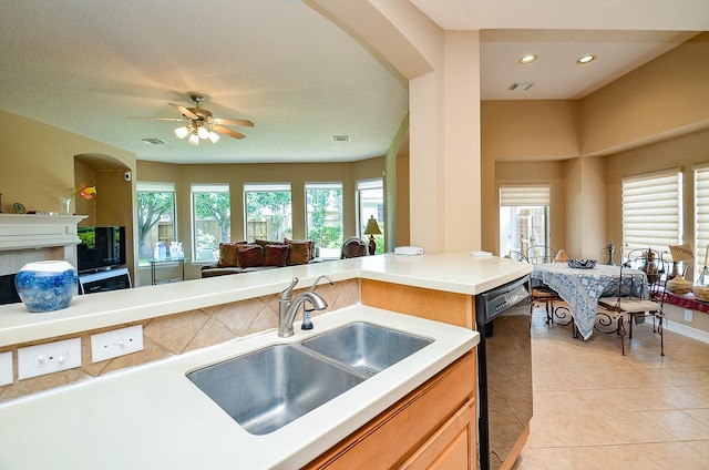 5703 Bent Arbor Ln, Katy, TX 77450 - kitchen with a sink, dishwasher, open floor plan, arched walkways, and light tile patterned floors