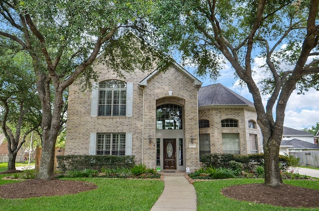 5703 Bent Arbor Ln, Katy, TX 77450 - french country home featuring brick siding and a front yard