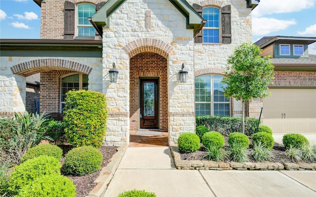 1417 Summer Field Ln, Friendswood, TX 77546 - doorway to property with stone siding, a garage, and brick siding