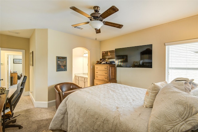 1417 Summer Field Ln, Friendswood, TX 77546 - bedroom with arched walkways, light carpet, baseboards, a ceiling fan, and ensuite bathroom