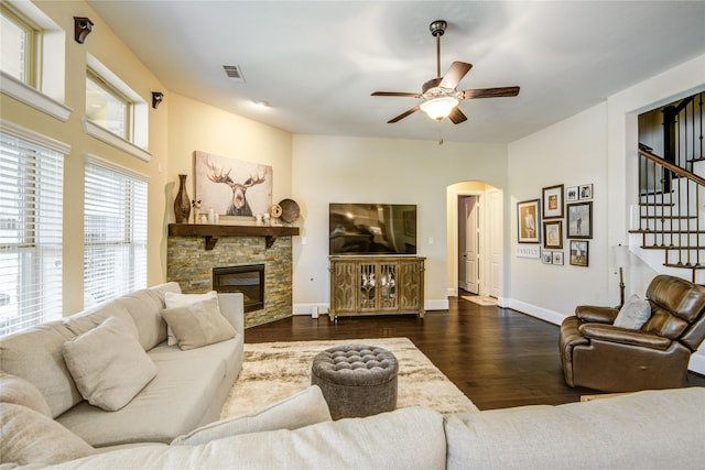 1417 Summer Field Ln, Friendswood, TX 77546 - living room featuring a ceiling fan, stairs, arched walkways, dark wood finished floors, and a fireplace