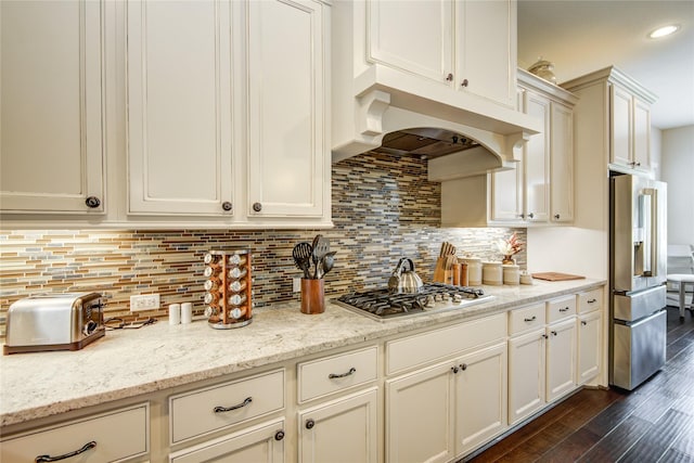 1417 Summer Field Ln, Friendswood, TX 77546 - kitchen featuring appliances with stainless steel finishes, dark wood-style flooring, decorative backsplash, light stone countertops, and recessed lighting