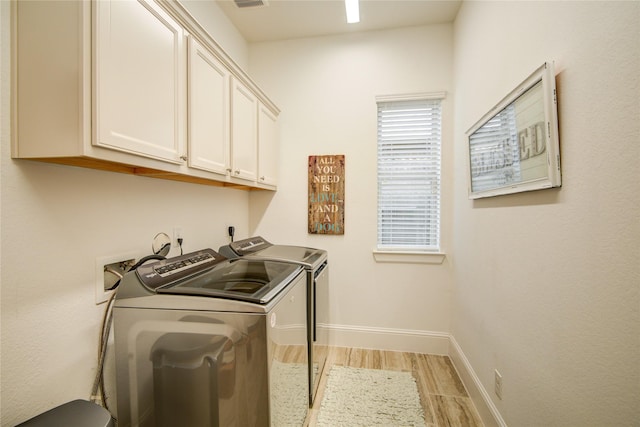 1417 Summer Field Ln, Friendswood, TX 77546 - laundry room with cabinet space, separate washer and dryer, light wood finished floors, and baseboards
