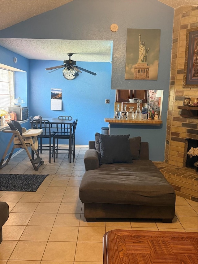 11110 Broken Sky Dr, Houston, TX 77064 - living room featuring light tile patterned flooring, lofted ceiling, ceiling fan, and a textured ceiling