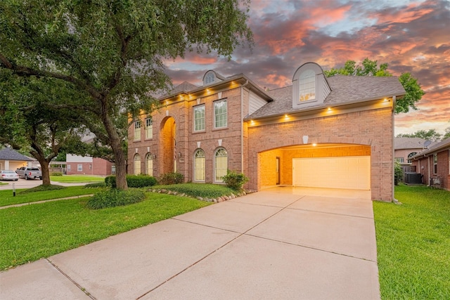 2003 Birnam Wood Dr, Sugar Land, TX 77479 - colonial inspired home with brick siding, a yard, concrete driveway, central air condition unit, and an attached garage