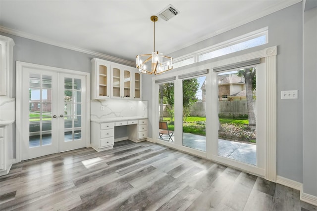 2003 Birnam Wood Dr, Sugar Land, TX 77479 - unfurnished living room featuring french doors, crown molding, a chandelier, light wood-style flooring, and baseboards