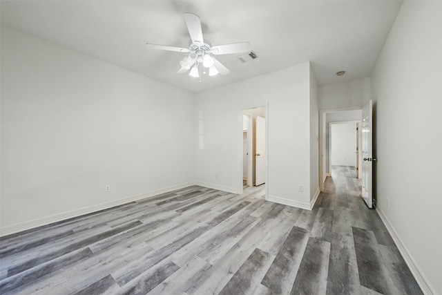 2003 Birnam Wood Dr, Sugar Land, TX 77479 - unfurnished bedroom with wood finished floors, baseboards, and a ceiling fan