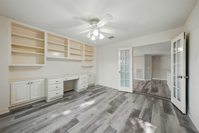 2003 Birnam Wood Dr, Sugar Land, TX 77479 - unfurnished office with french doors, built in desk, a ceiling fan, light wood-style floors, and baseboards