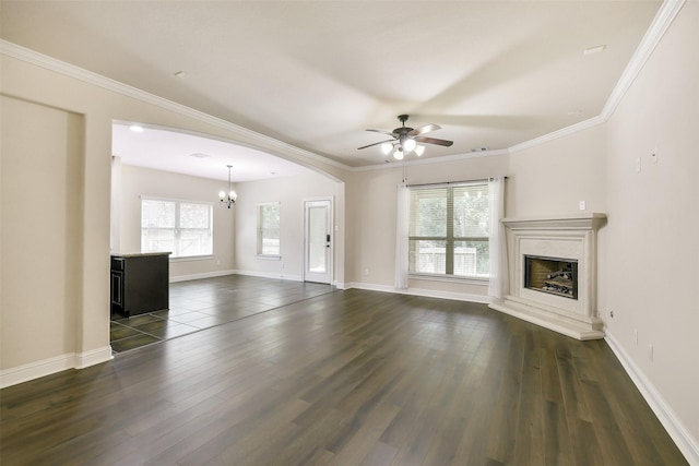 139 S Ridge Park Dr, Magnolia, TX 77354 - unfurnished living room featuring a fireplace with raised hearth, ceiling fan, a chandelier, dark wood-style floors, and crown molding