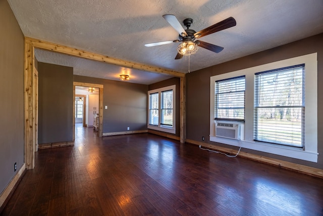 2175 Fm 1725th Rd, Cleveland, TX 77328 - unfurnished room featuring a textured ceiling, baseboards, dark wood-style floors, ceiling fan, and cooling unit