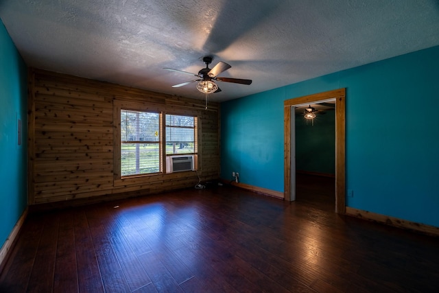 2175 Fm 1725th Rd, Cleveland, TX 77328 - spare room featuring a textured ceiling, ceiling fan, hardwood / wood-style flooring, baseboards, and wooden walls