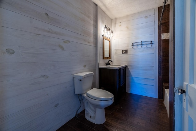 2175 Fm 1725th Rd, Cleveland, TX 77328 - bathroom featuring toilet, vanity, wood finished floors, wooden walls, and bathtub / shower combination