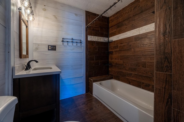 2175 Fm 1725th Rd, Cleveland, TX 77328 - full bathroom featuring shower / tub combination, vanity, wood walls, toilet, and a textured ceiling