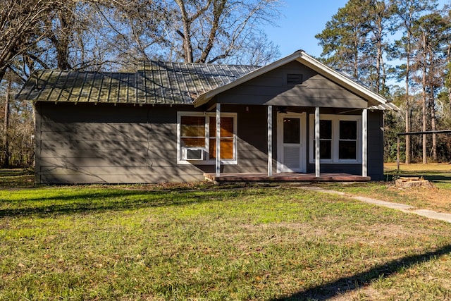 2175 Fm 1725th Rd, Cleveland, TX 77328 - view of front of house featuring a porch, a front lawn, and metal roof