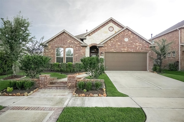 18711 Big Elm Dr, Cypress, TX 77433 - view of front of home featuring brick siding, a garage, and driveway