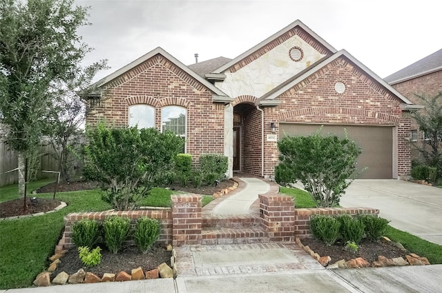 18711 Big Elm Dr, Cypress, TX 77433 - french country inspired facade featuring brick siding, concrete driveway, and an attached garage