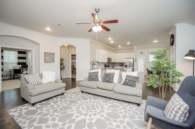 18711 Big Elm Dr, Cypress, TX 77433 - living area with arched walkways, light wood-style flooring, ceiling fan, ornamental molding, and recessed lighting
