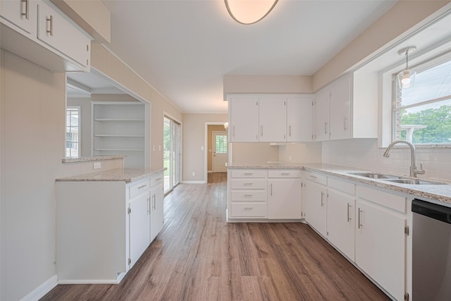 1316 Courtney St, Richmond, TX 77469 - kitchen featuring a sink, dishwasher, wood finished floors, white cabinets, and baseboards
