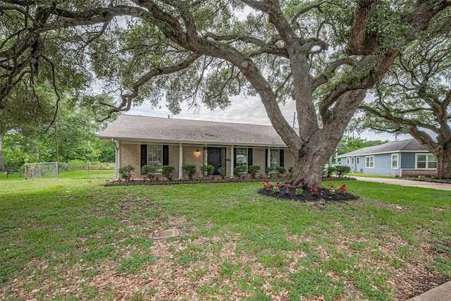 1316 Courtney St, Richmond, TX 77469 - ranch-style house with a front yard, brick siding, covered porch, and a shingled roof