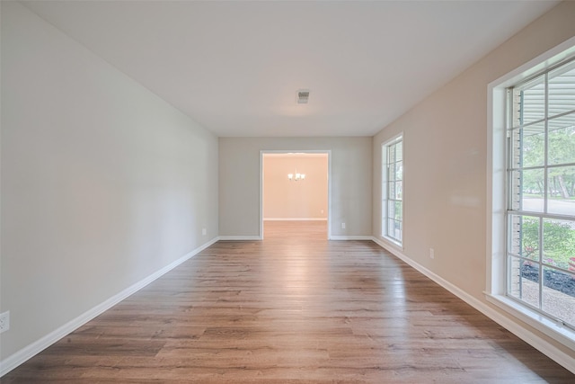 1316 Courtney St, Richmond, TX 77469 - unfurnished room with light wood-style floors, a chandelier, and baseboards